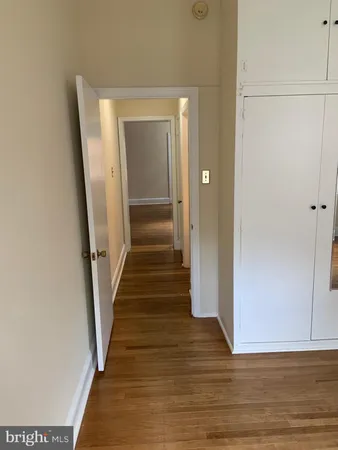 a view of a hallway with wooden floor and entryway