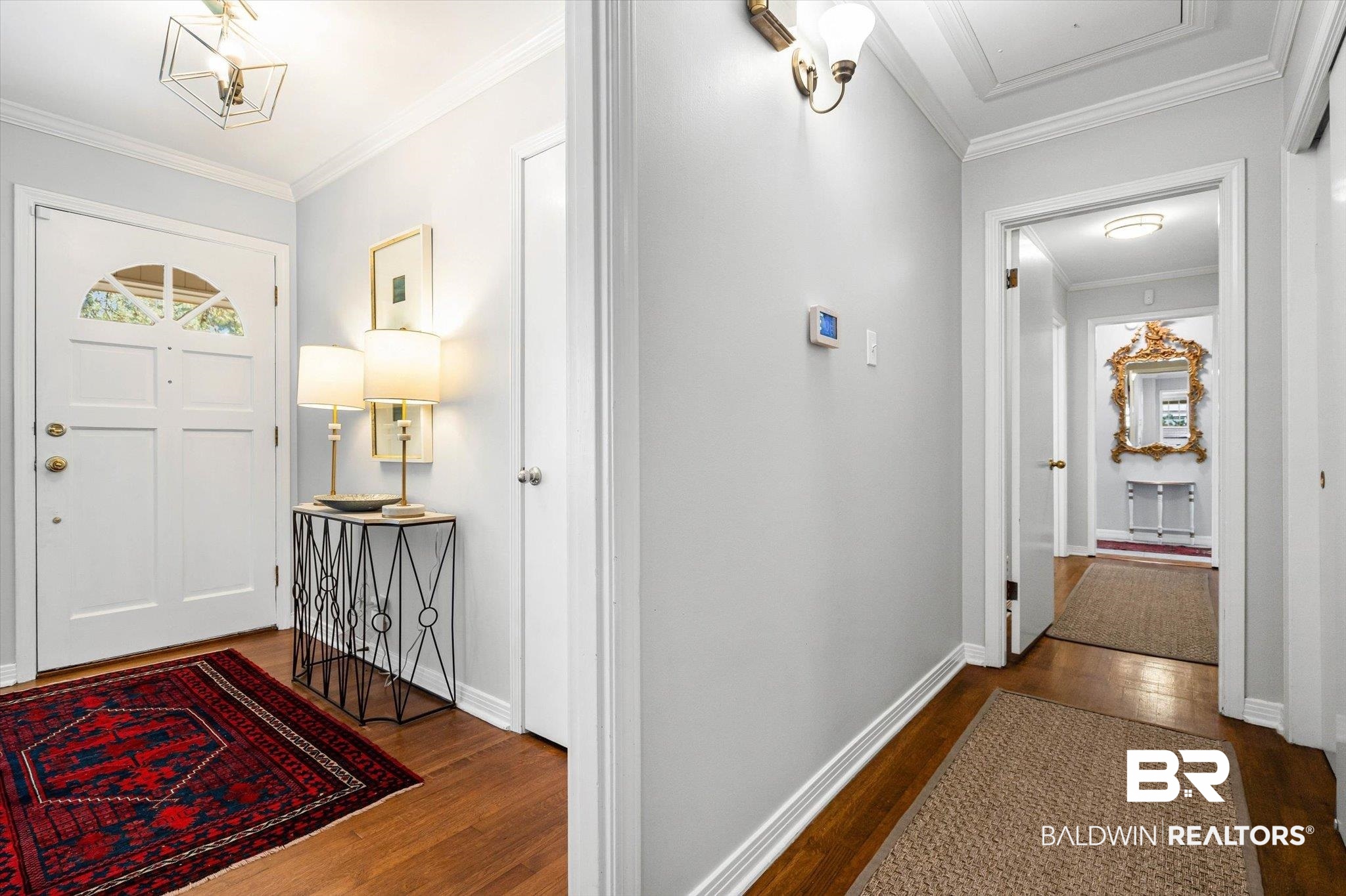 313 Brawood Drive Mobile, AL 36608 - Photo 13 of 32 Entrance foyer with crown molding and dark wood-style floors
