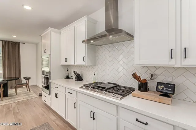 a kitchen with stainless steel appliances granite countertop a sink stove and cabinets