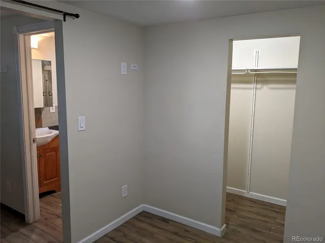 a view of small space with wooden floor and a window
