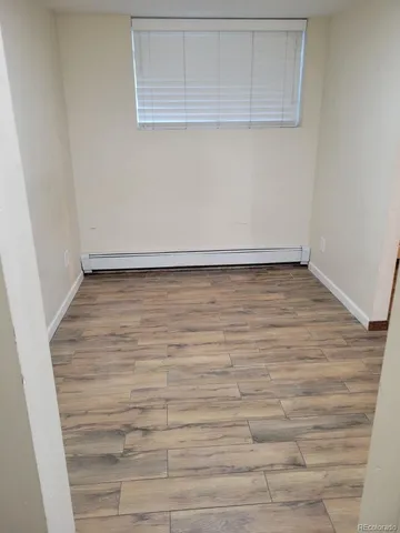 a view of a room with wooden floor