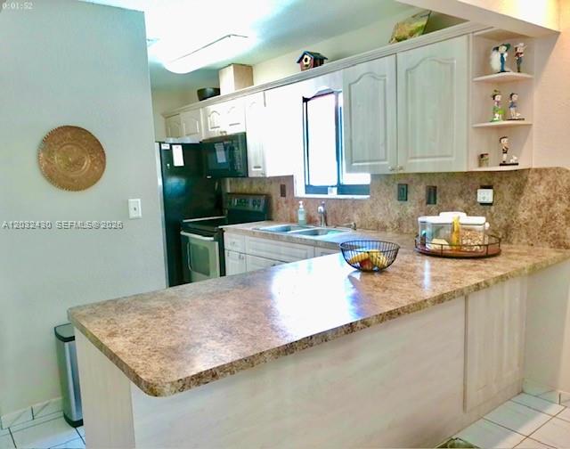 6527 West 22nd Lane Hialeah, FL 33016 - Photo 5 of 18 a kitchen with stainless steel appliances granite countertop a sink dishwasher stove and cabinets