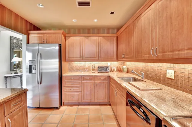 a dining room with furniture water view and a floor to ceiling window