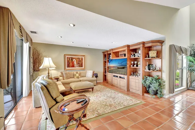 a view of a patio with table and chairs with wooden floor and fence