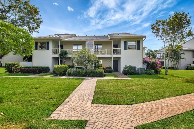 a view of a hallway with a dining table and chairs