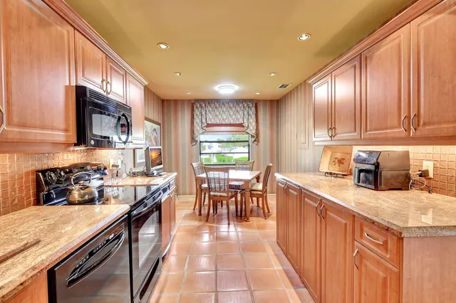 a living room with furniture a flat screen tv and a floor to ceiling window