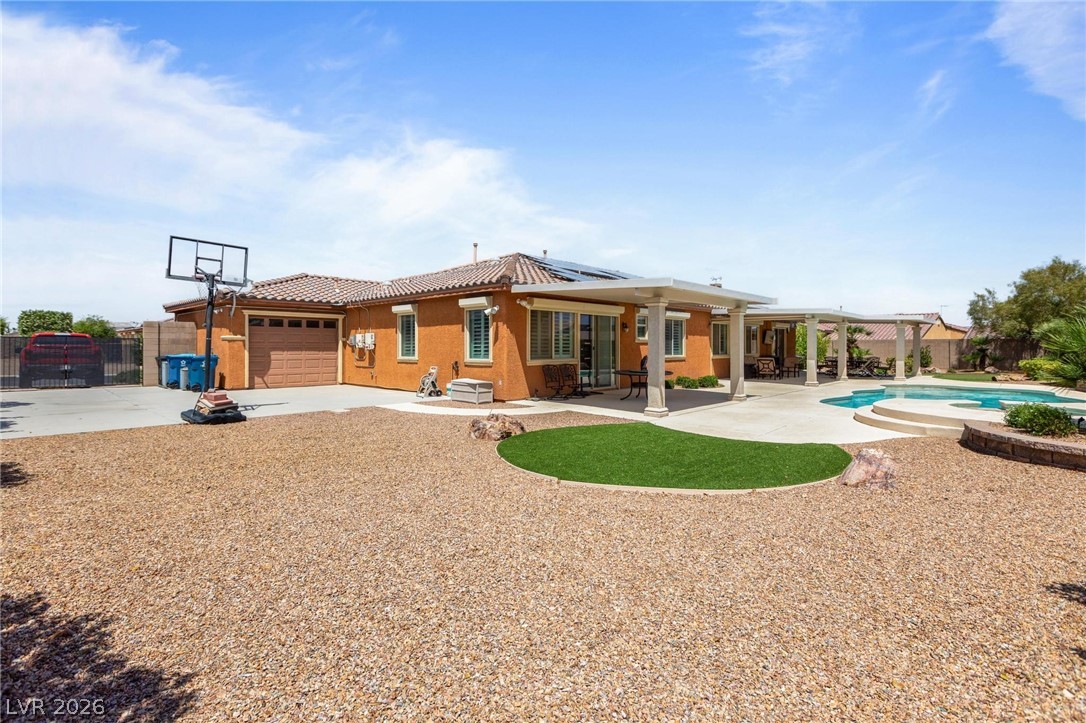 8431 Durango Ranch Court Las Vegas, NV 89113 - Photo 40 of 49 This spacious backyard features a refreshing pool and an inviting patio, perfect for outdoor enjoyment.