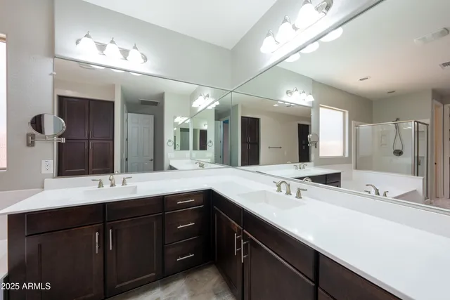 a bathroom with a sink double vanity and a mirror