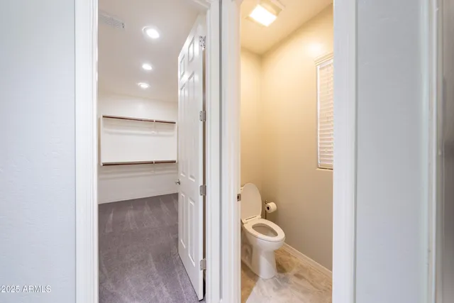 a bathroom with a toilet sink and shower