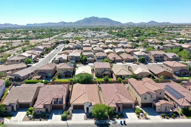 an aerial view of residential houses with city view