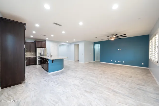 a view of a kitchen with a refrigerator and a kitchen counter top