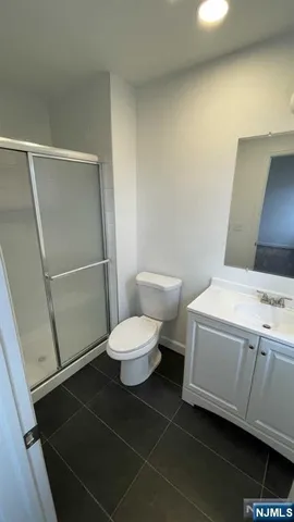 a bathroom with a toilet a sink and a shower