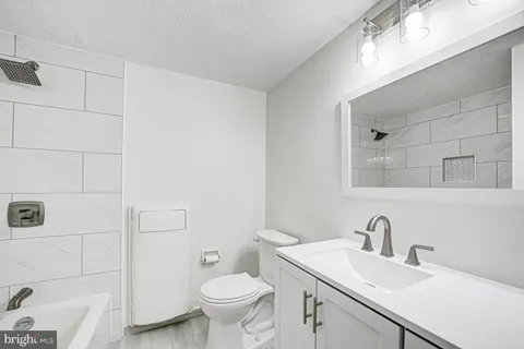 a bathroom with a sink toilet and vanity
