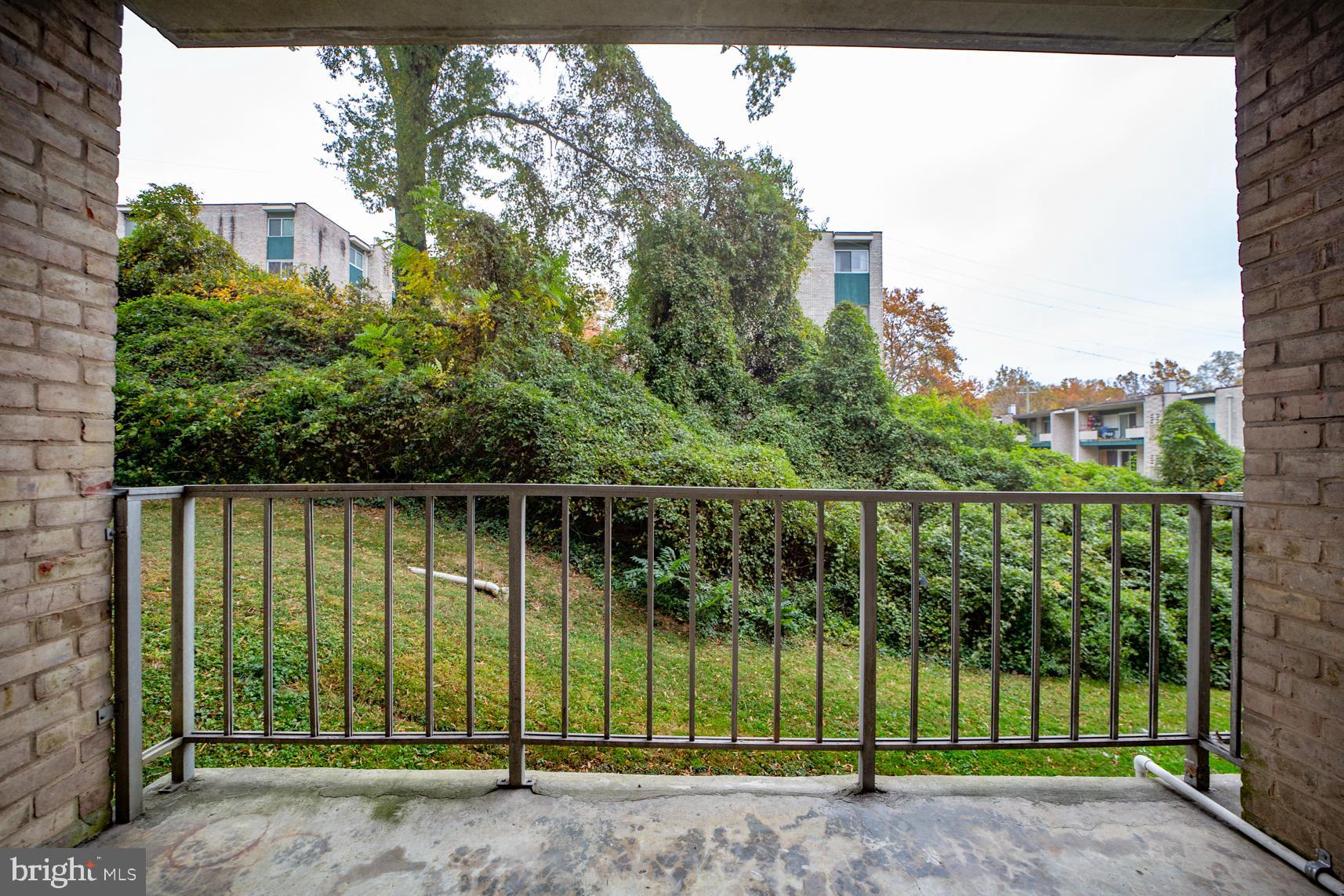 9250 Edwards Way, Unit 207A Hyattsville, MD 20783 - Photo 13 of 17 a view of a house with a backyard