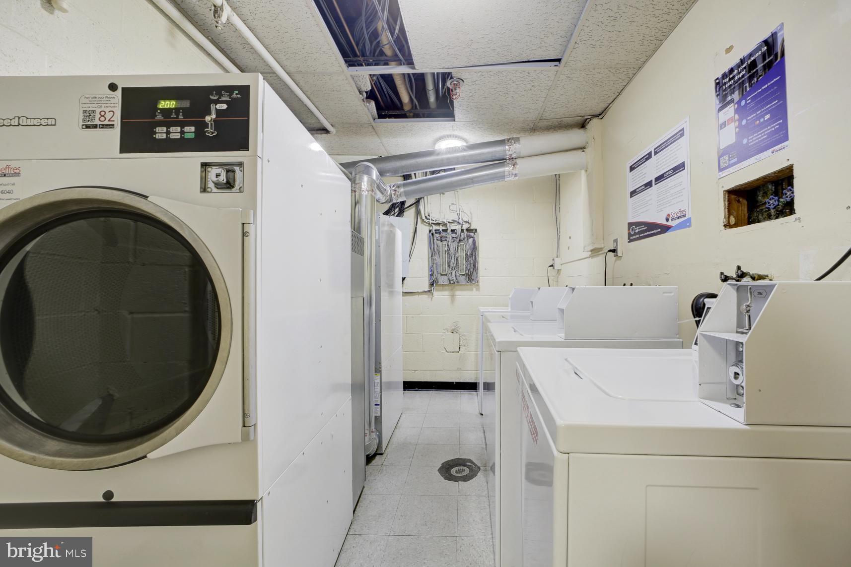 9250 Edwards Way, Unit 207A Hyattsville, MD 20783 - Photo 15 of 17 a utility room with dryer and washer