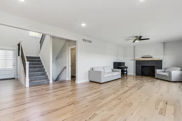 a living room with furniture and a wooden floor
