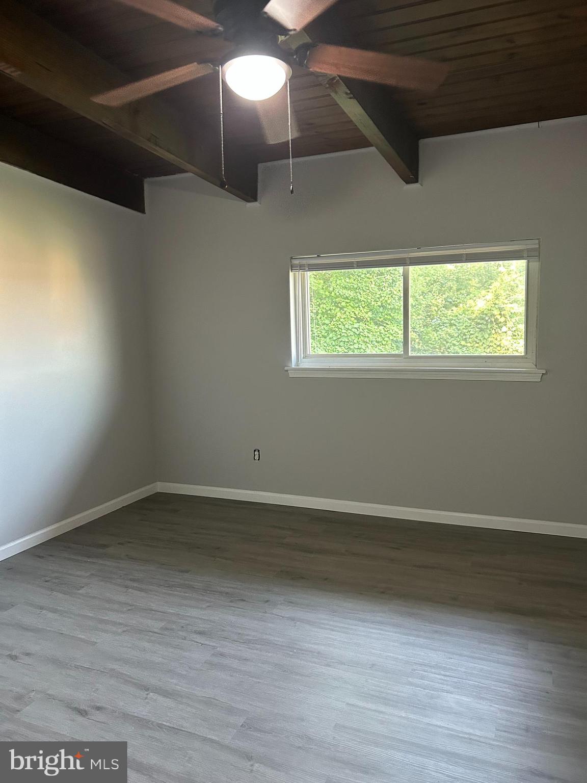 7701 Arehart Drive, Unit 1314 New Carrollton, MD 20784 - Photo 11 of 13 an empty room with wooden floor and windows