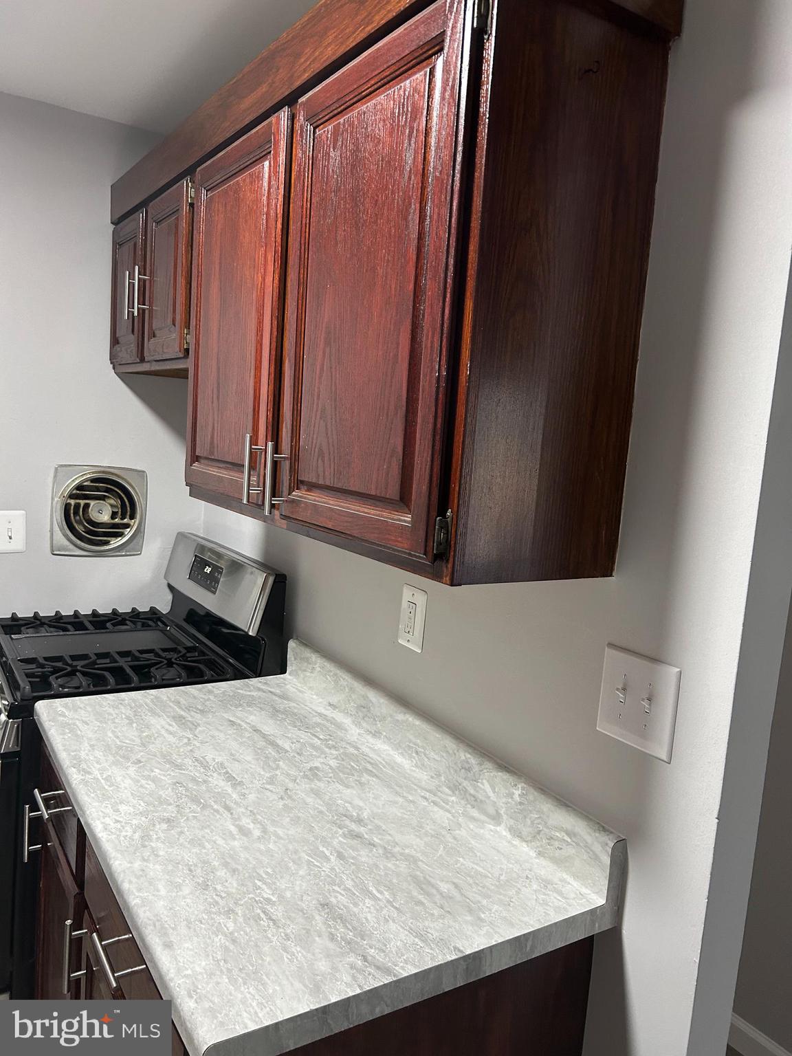 7701 Arehart Drive, Unit 1314 New Carrollton, MD 20784 - Photo 8 of 13 a kitchen with a stove and a microwave