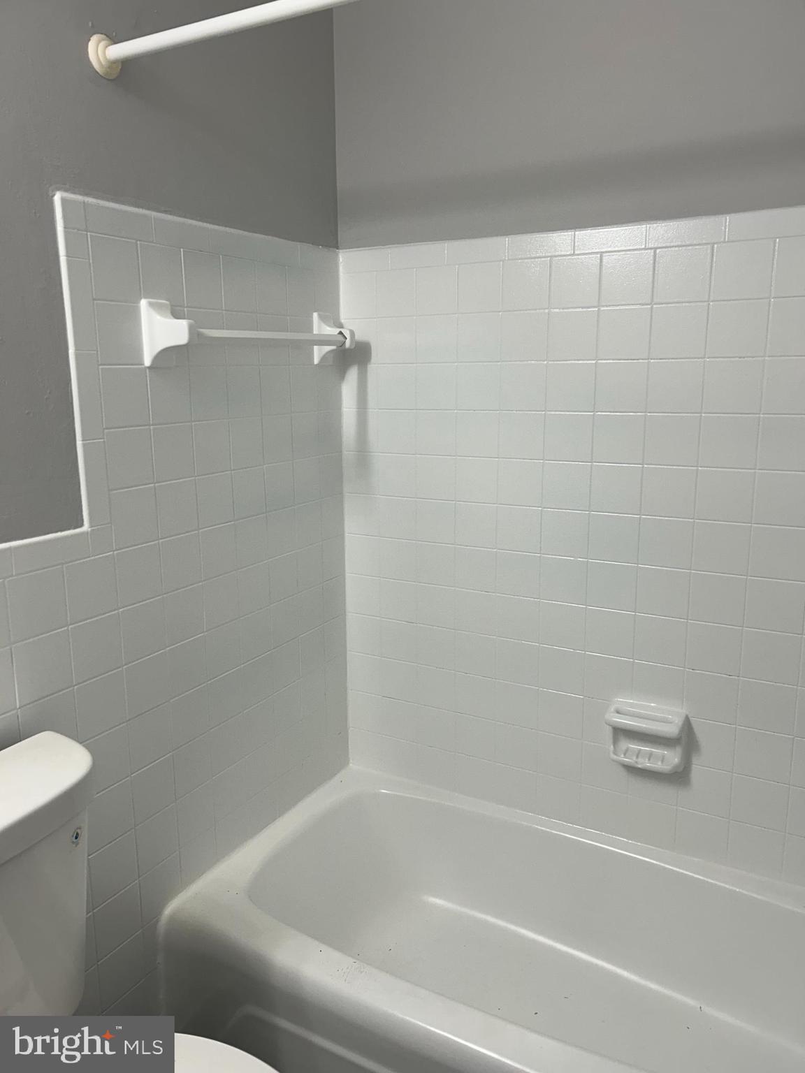 7701 Arehart Drive, Unit 1314 New Carrollton, MD 20784 - Photo 9 of 13 a bathroom with a shower and a toilet