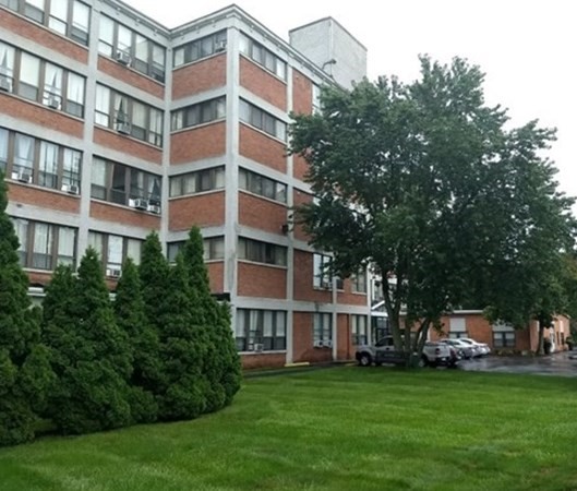 60 North Main Street, Unit 410 Natick, MA 01760 - Photo 2 of 5 a view of a building with a yard