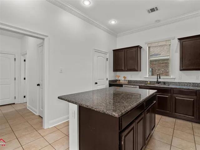a kitchen with stainless steel appliances granite countertop a sink and dishwasher stove top oven with granite countertops
