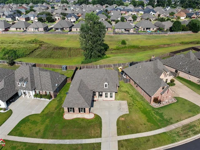 an aerial view of a house with a yard