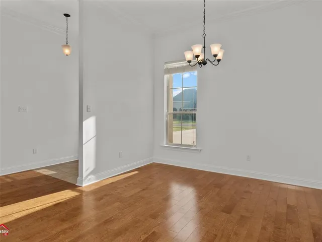 a view of a room with a chandeliers fan