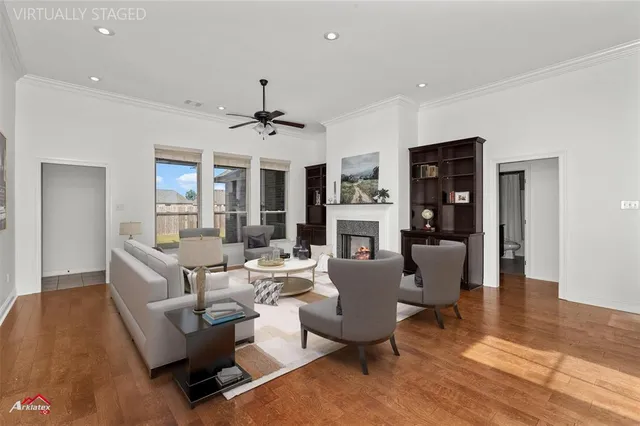 a living room with furniture and a wooden floor