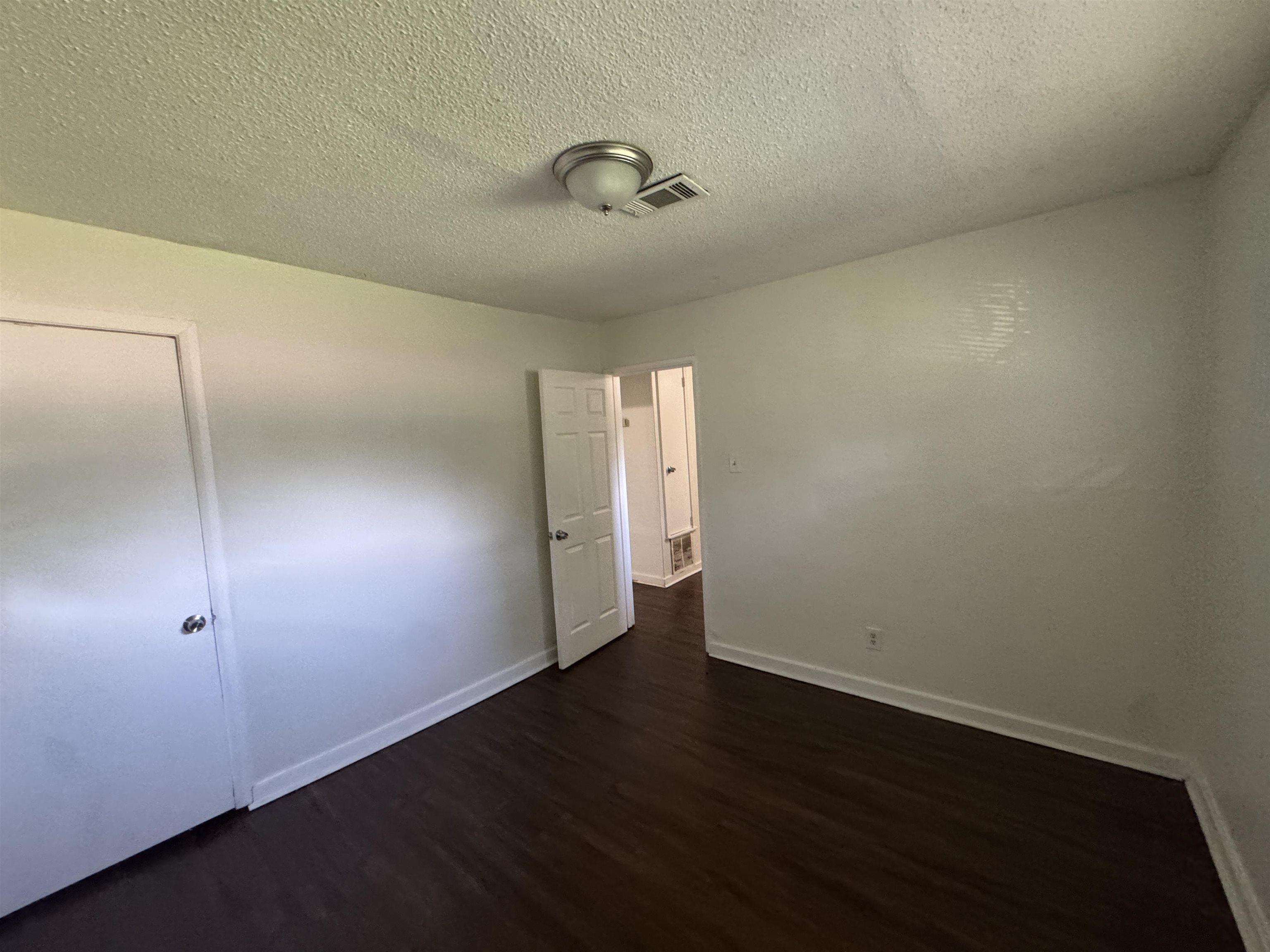 761 Harahan Road Memphis, TN 38109 - Photo 9 of 9 Interior room featuring dark wood-finish flooring, white walls, and a ceiling-mounted light fixture