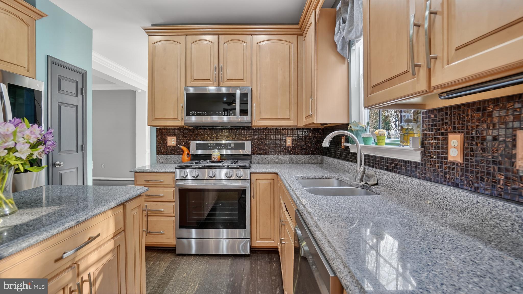 2801 Klein Court Crofton, MD 21114 - Photo 16 of 46 a kitchen with stainless steel appliances granite countertop a sink a stove and a wooden cabinets