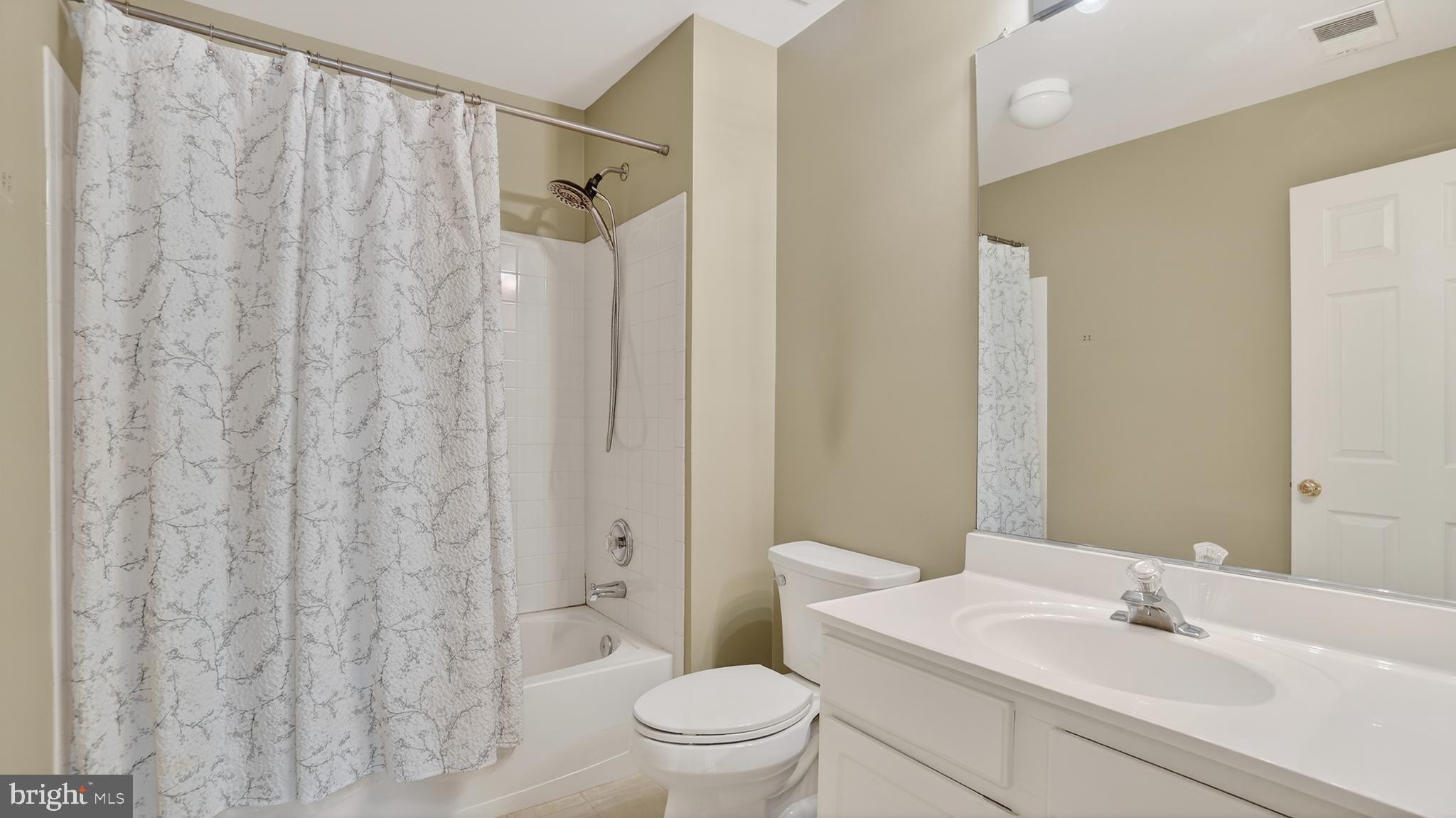 2801 Klein Court Crofton, MD 21114 - Photo 30 of 46 a bathroom with a sink a toilet and shower curtain