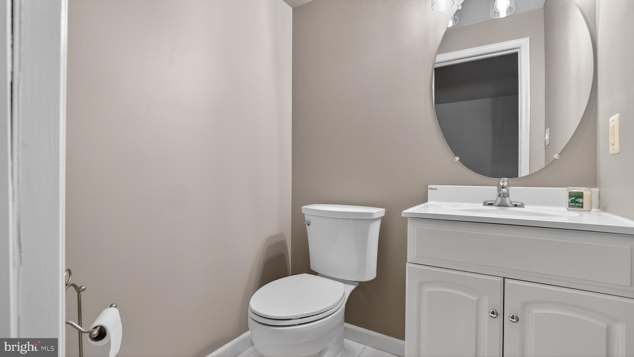 2801 Klein Court Crofton, MD 21114 - Photo 37 of 46 a bathroom with a toilet sink and mirror