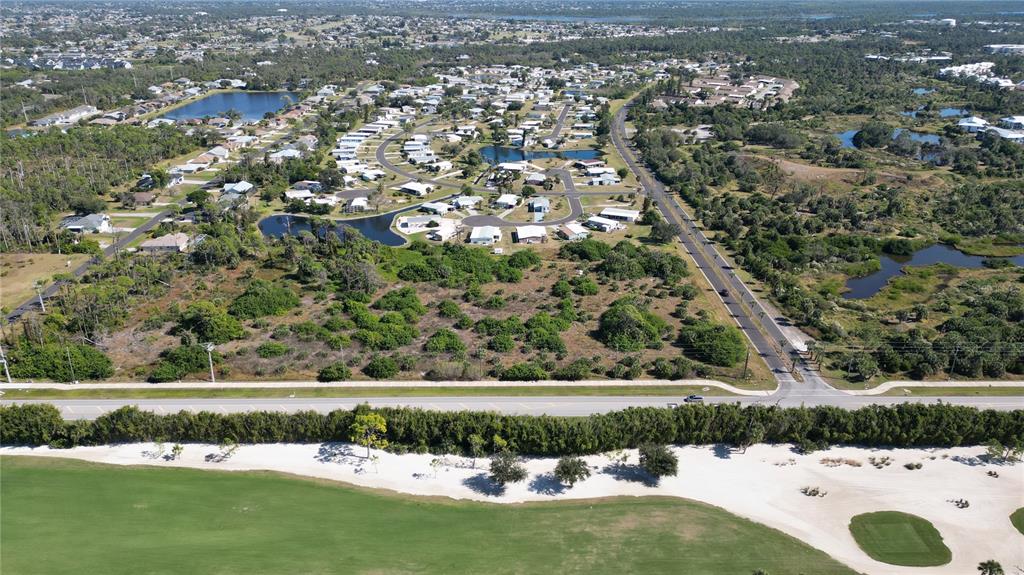 6691 Placida Road Englewood, FL 34224 - Photo 1 of 5 an aerial view of a golf course with a lake view