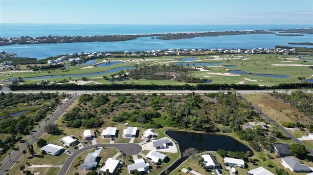 an aerial view of a city with lots of residential buildings lake and ocean view