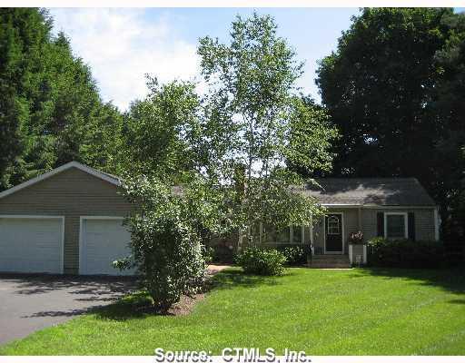 11 Riverside Road Simsbury, CT 06070 - Photo 1 of 1 a front view of a house with a yard and trees