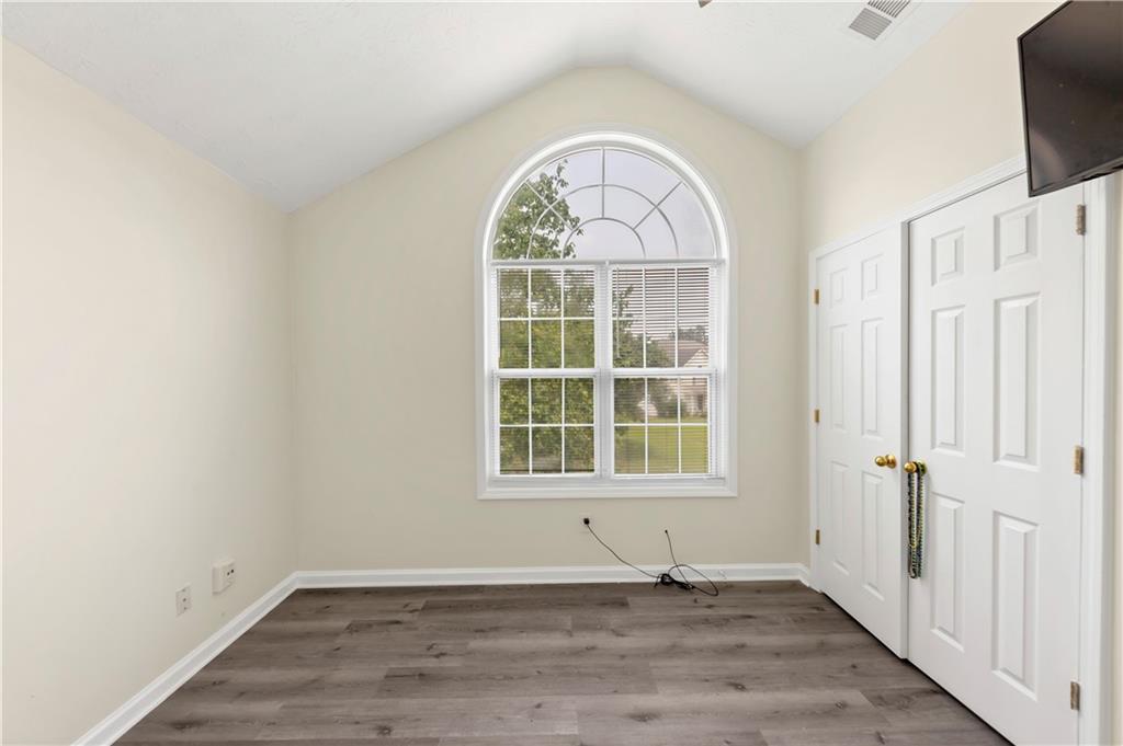 2880 Field Spring Drive Lithonia, GA 30058 - Photo 20 of 31 an empty room with wooden floor cabinet and windows
