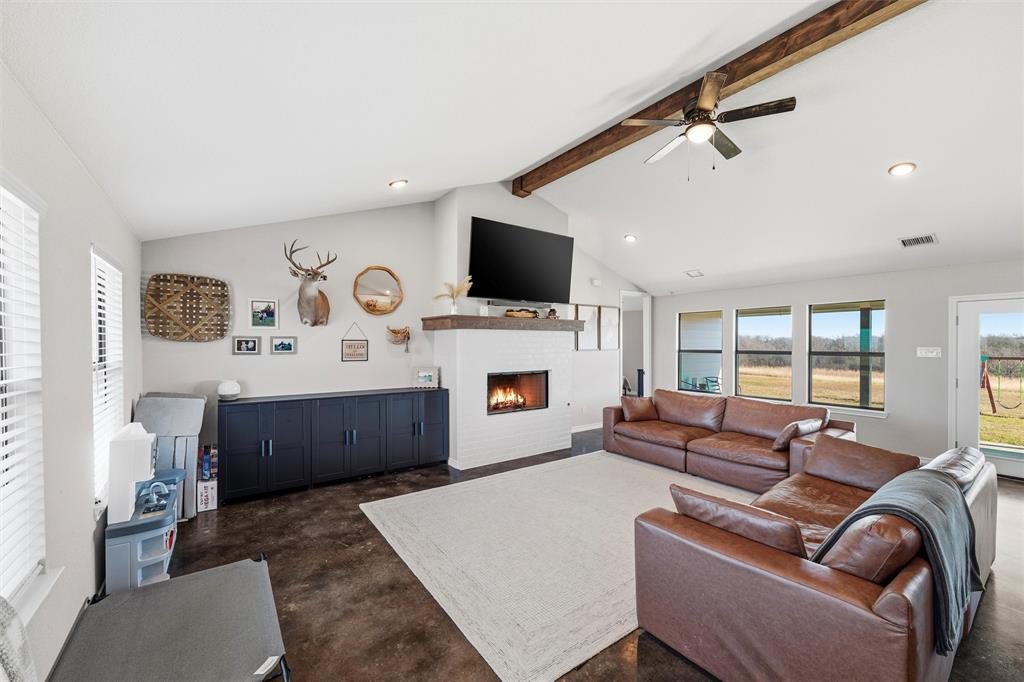 861 Richland Bnd Road Milford, TX 76670 - Photo 14 of 38 a living room with furniture a flat screen tv and a fireplace