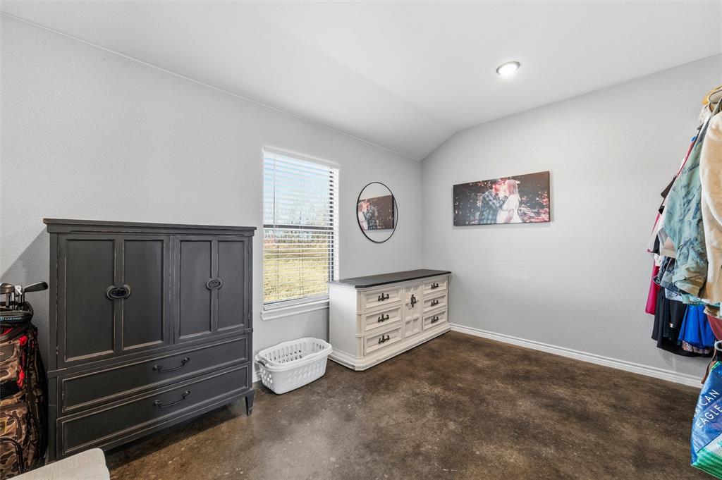 861 Richland Bnd Road Milford, TX 76670 - Photo 19 of 38 a bedroom with a bed and a cabinets
