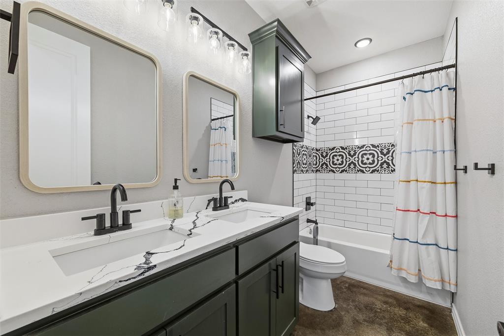 861 Richland Bnd Road Milford, TX 76670 - Photo 23 of 38 a bathroom with a double vanity sink toilet and shower