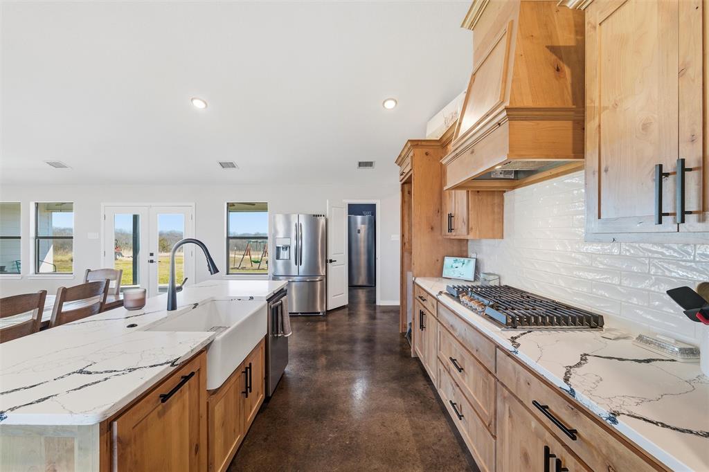 861 Richland Bnd Road Milford, TX 76670 - Photo 7 of 38 a open kitchen with stainless steel appliances granite countertop a stove and a sink