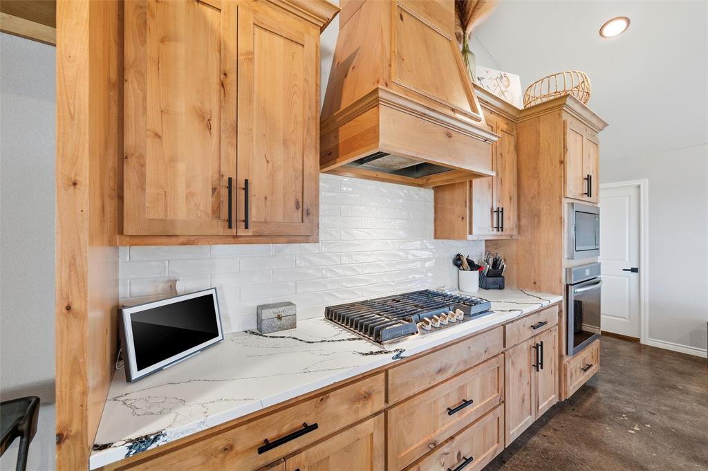 861 Richland Bnd Road Milford, TX 76670 - Photo 8 of 38 a kitchen with stainless steel appliances granite countertop a stove a sink and a microwave