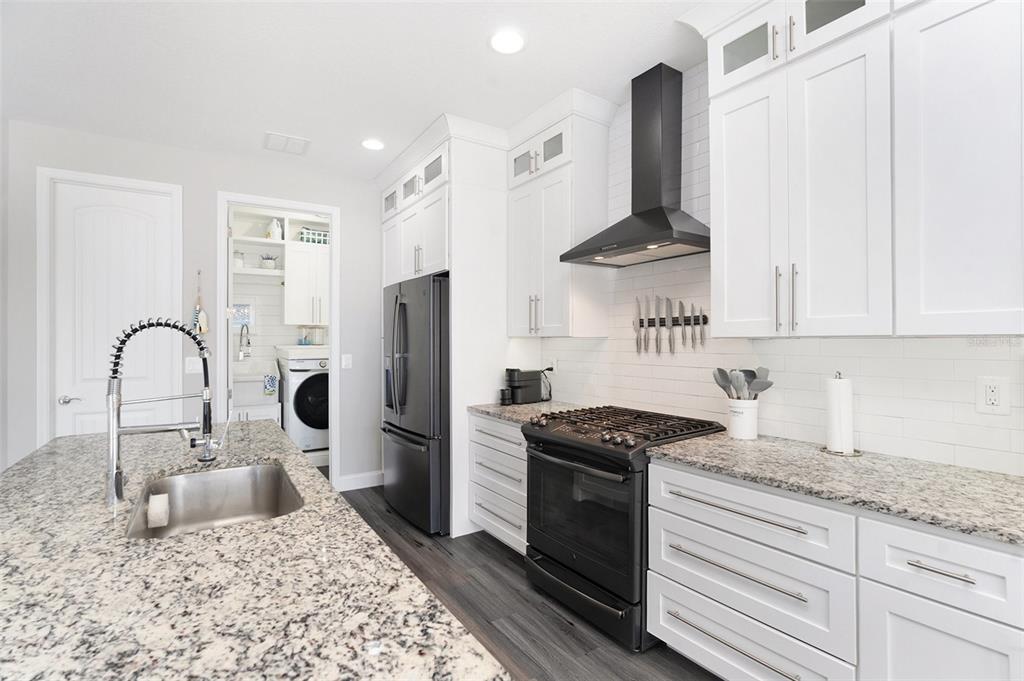 6408 Key Island Avenue Apollo Beach, FL 33572 - Photo 20 of 54 a kitchen with stainless steel appliances granite countertop a sink stove and refrigerator