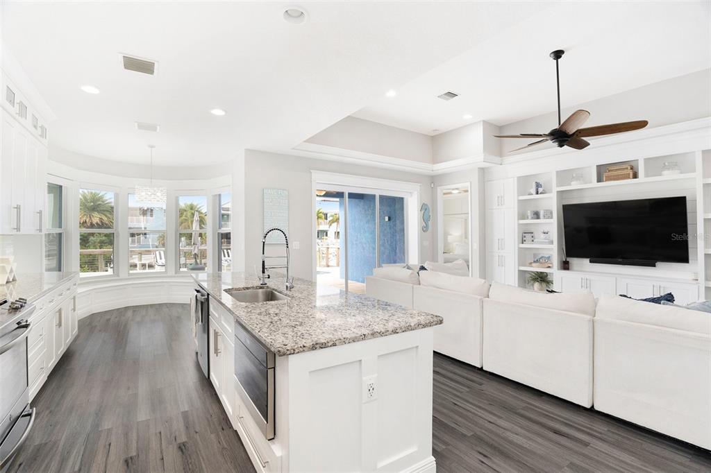 6408 Key Island Avenue Apollo Beach, FL 33572 - Photo 21 of 54 a view of living room with kitchen island furniture and flat screen tv