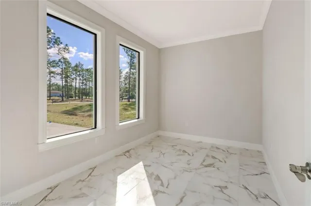 a view of a room with wooden floor and a window