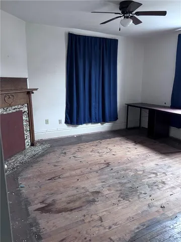 a view of an empty room with a fireplace