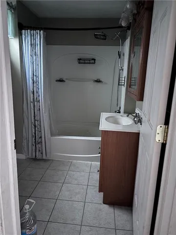 a bathroom with a shower and a sink