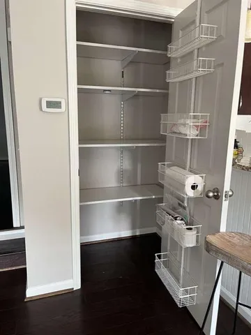 a room with a book shelf with wooden floor