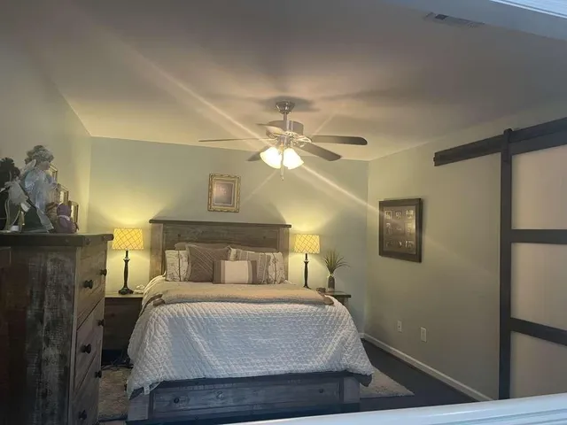 a bedroom with a bed and window