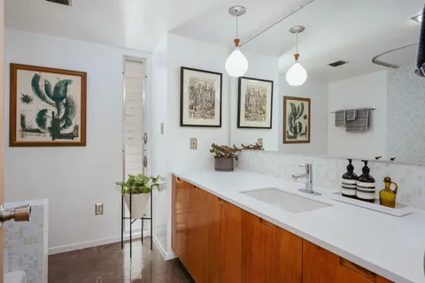 a bathroom with a sink a mirror and a bathtub