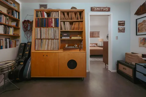 a view of a workspace with furniture and a window